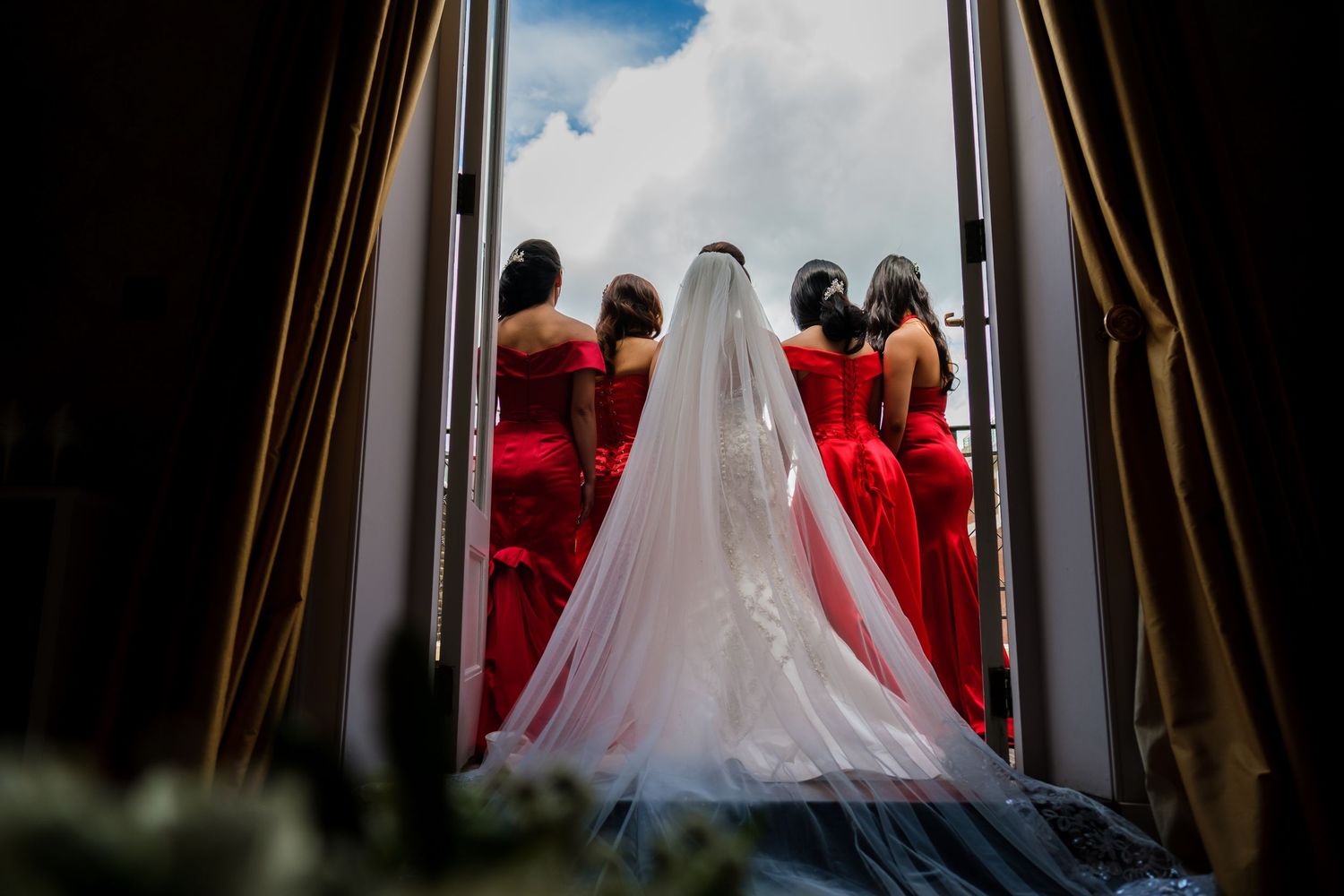 Wedding ceremony guests seated in elegant cathedral with arched stone columns and natural light streaming in.