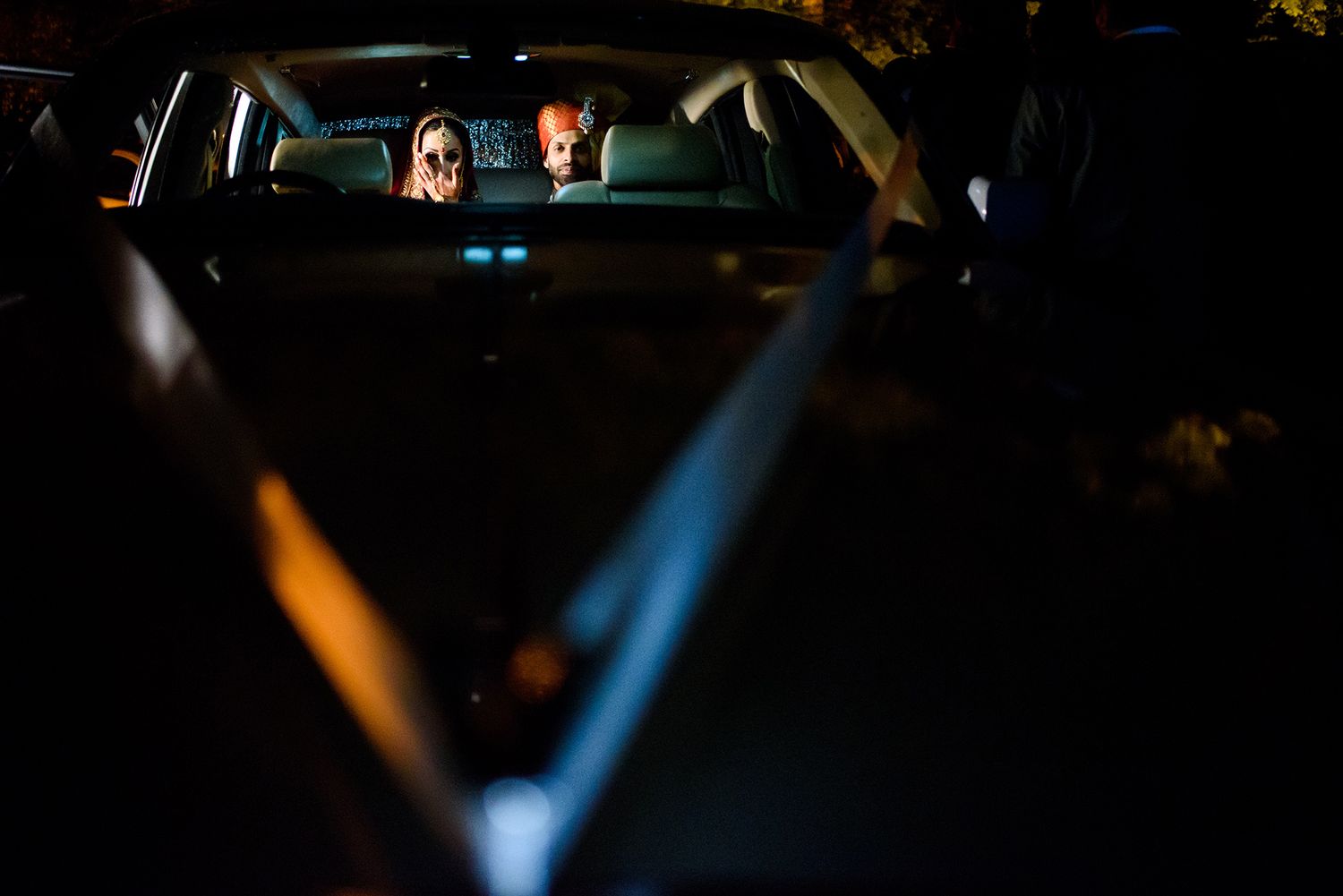 Nighttime celebration with dramatic blue spotlights illuminating the scene.