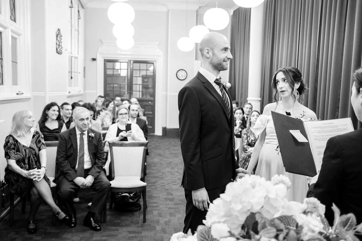 Black and white photo series of a wedding reception with guests enjoying themselves.