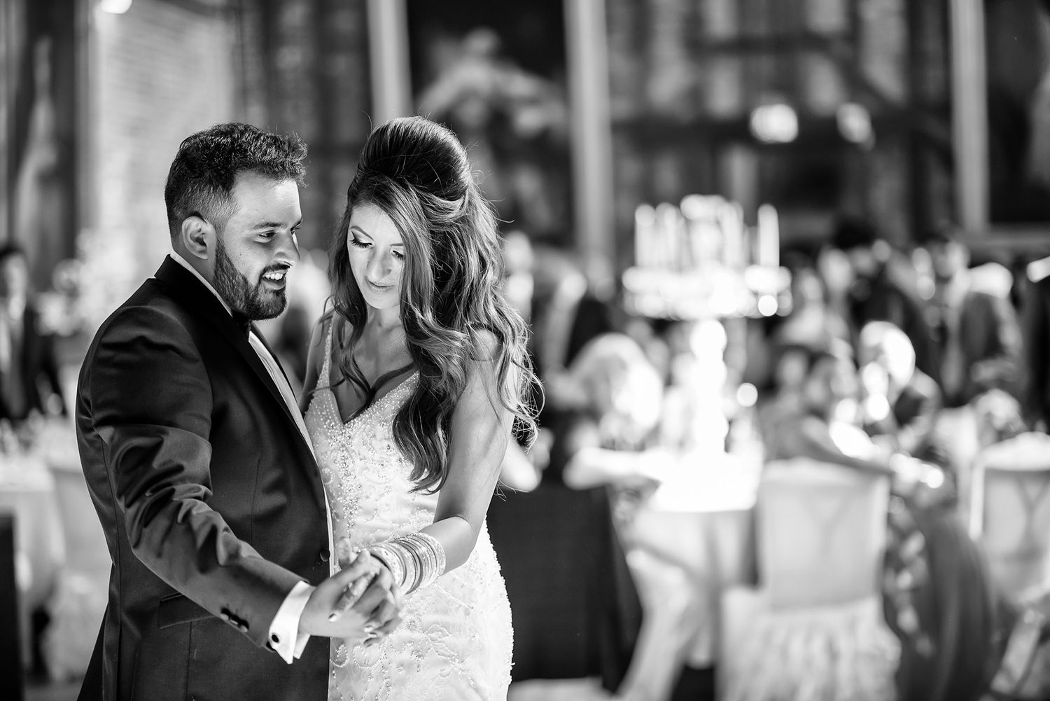 Candid black and white reception moments showing joyful celebration and laughter.