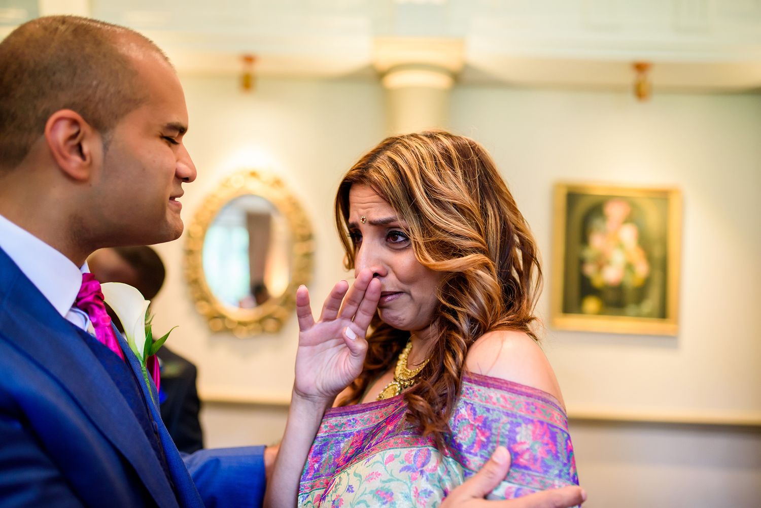 An intimate wedding moment captured in a beautifully decorated room with classic decor.