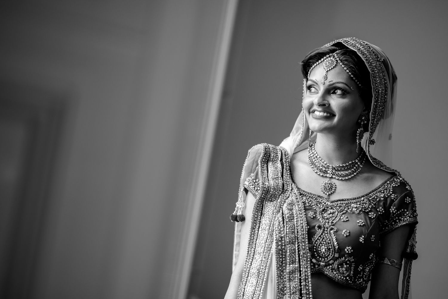 Black and white portraits showing traditional Indian bridal jewelry and attire preparations.