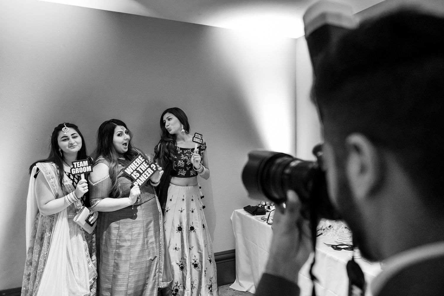 High-contrast black and white shot of guests at a formal celebration.