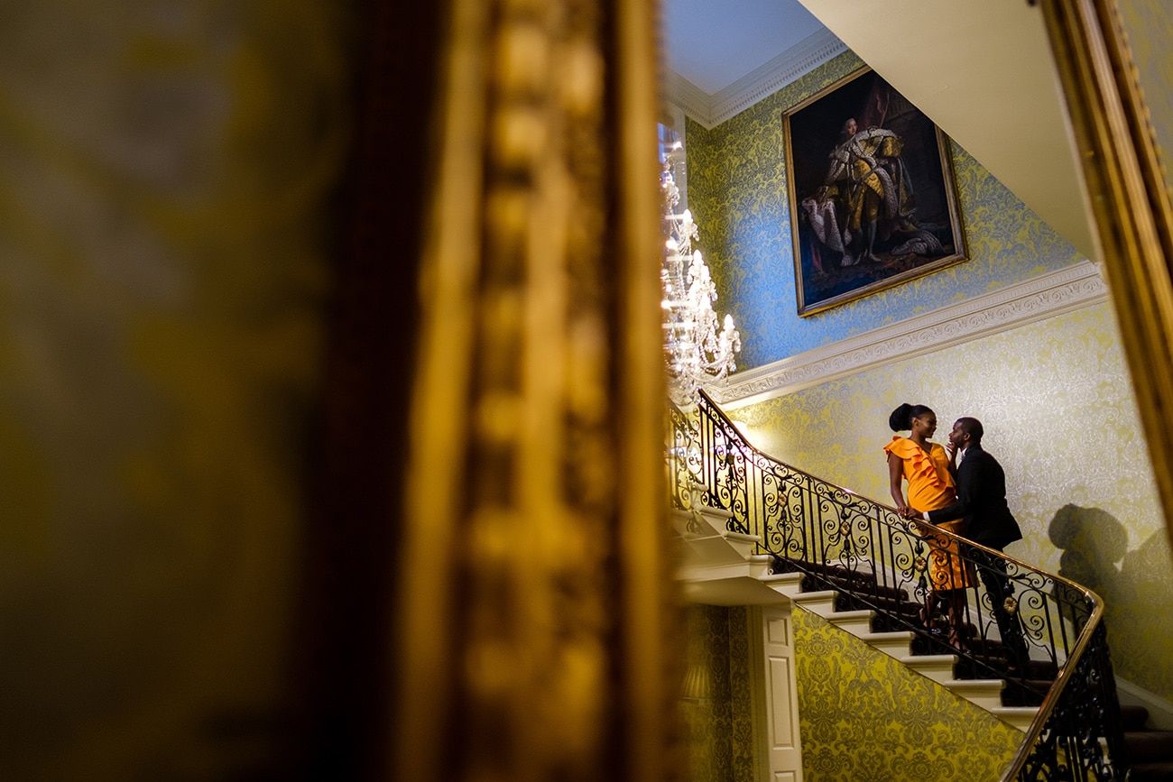 An elegant staircase with ornate railings inside a historic mansion.