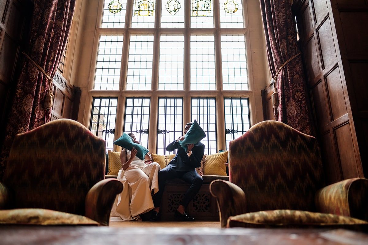 Artistic wedding photo composition with dramatic window lighting in historic venue.