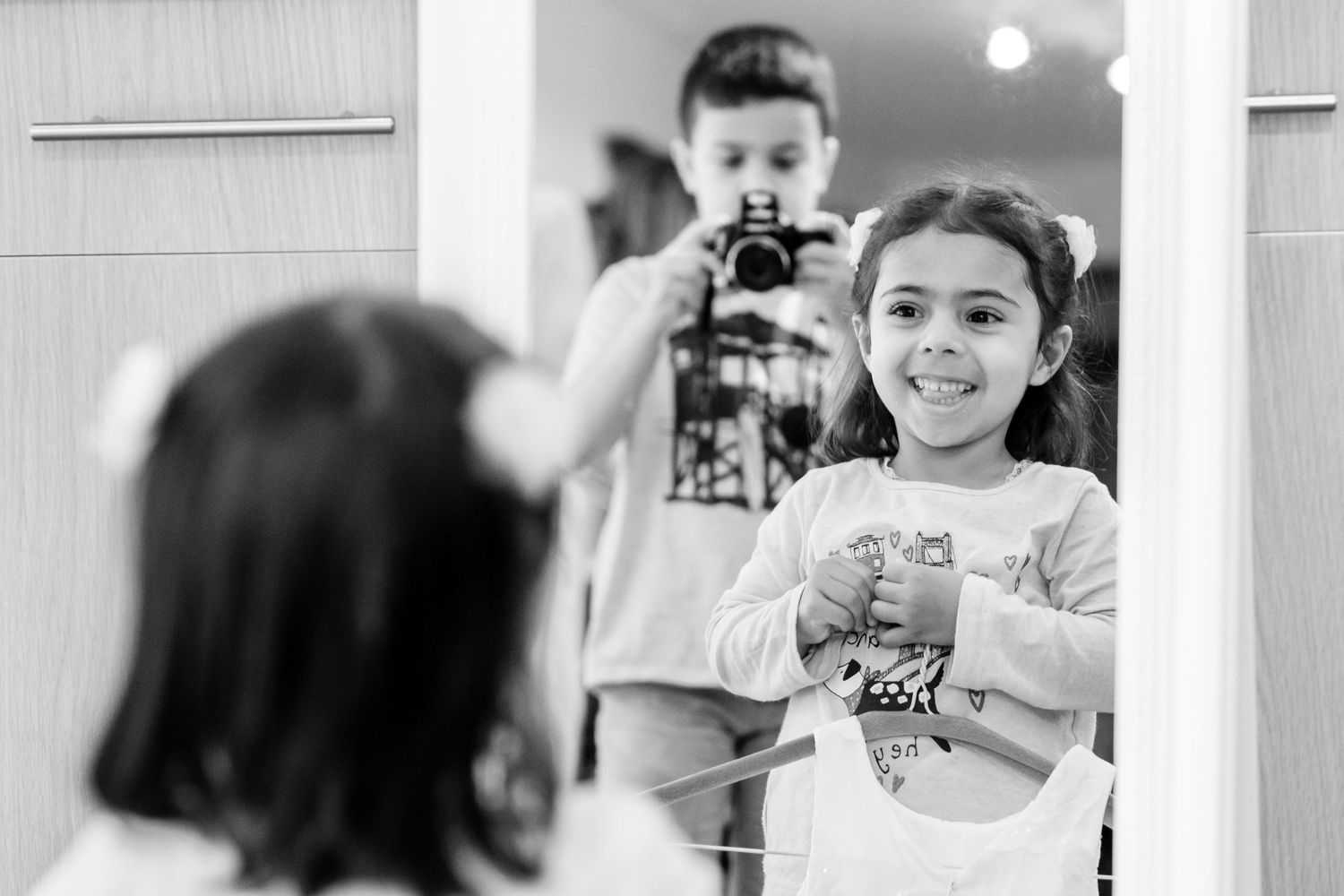 Black and white candid shots of children playing and interacting.