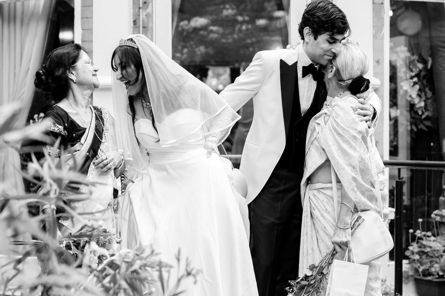 A collection of romantic black and white wedding photographs showcasing loving couples embracing and dancing in formal attire.