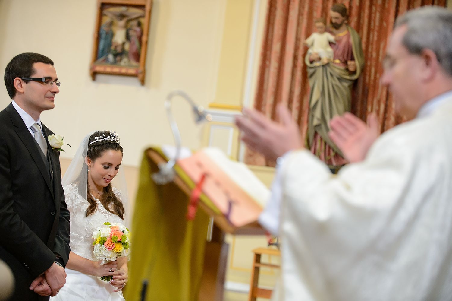 Religious wedding ceremony taking place inside traditional church setting.