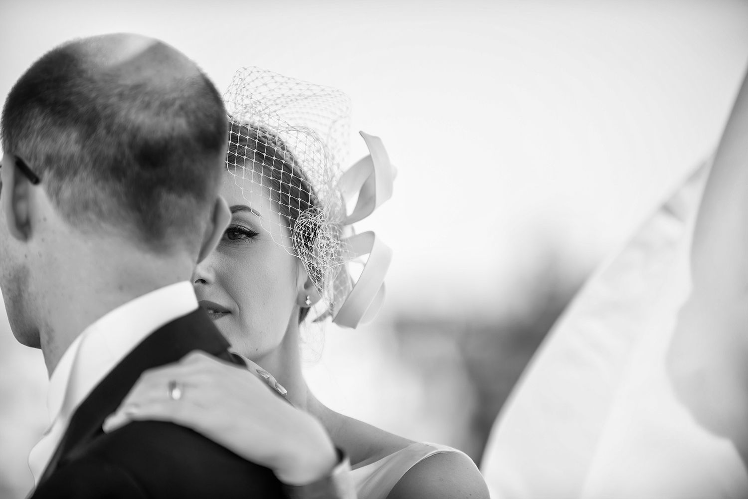 Intimate wedding moment captured in soft black and white photography.