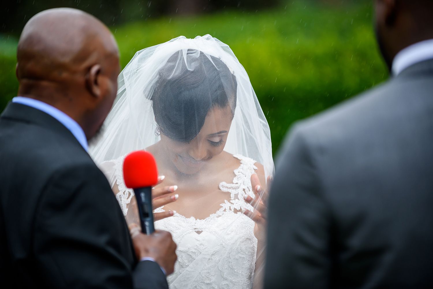 Close-up wedding ceremony moments captured against vibrant green outdoor backdrop.