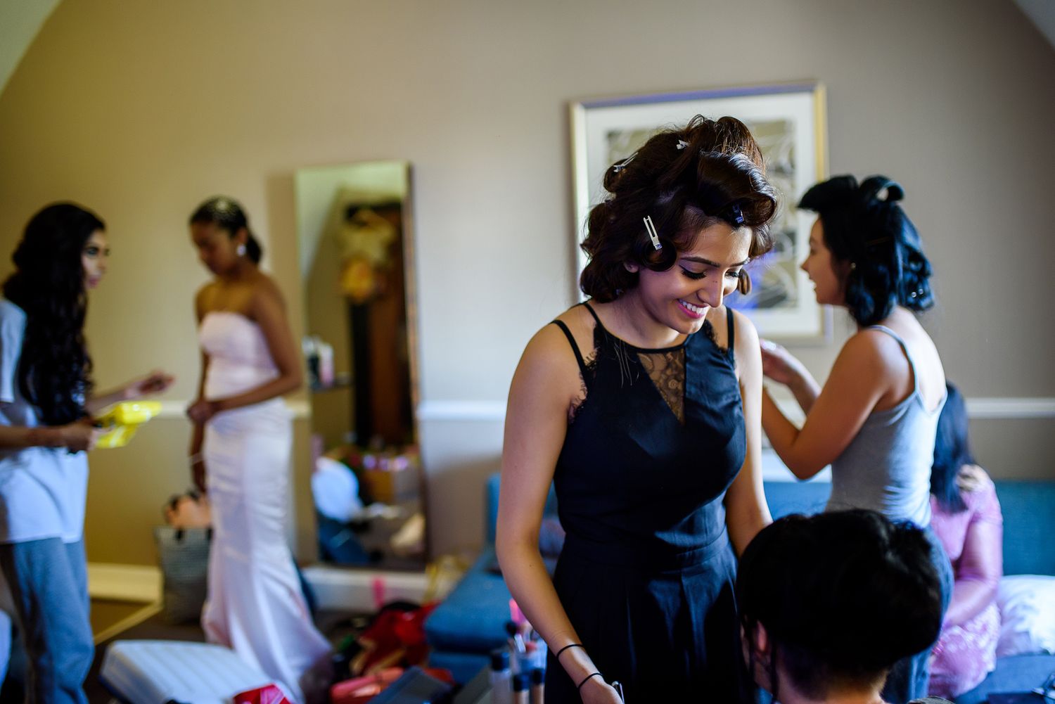 Wedding preparations taking place in a sunlit room with people getting ready.