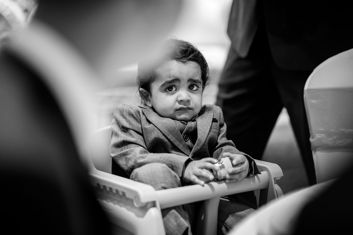Black and white candid photograph of young children during a celebration.