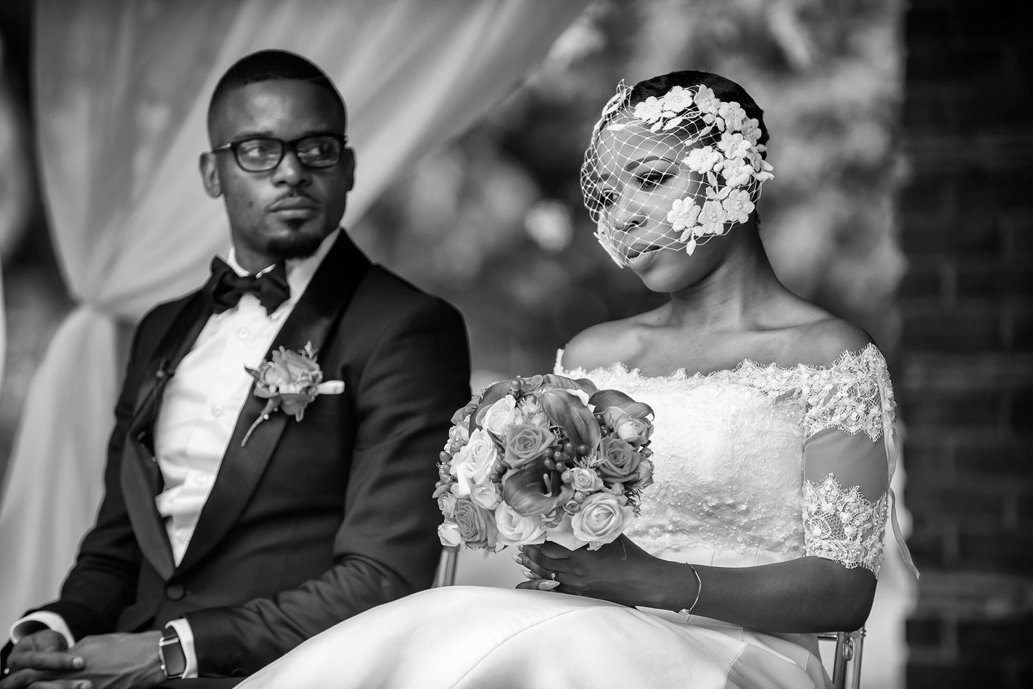 Formal wedding reception scene with elegant table settings and decor.