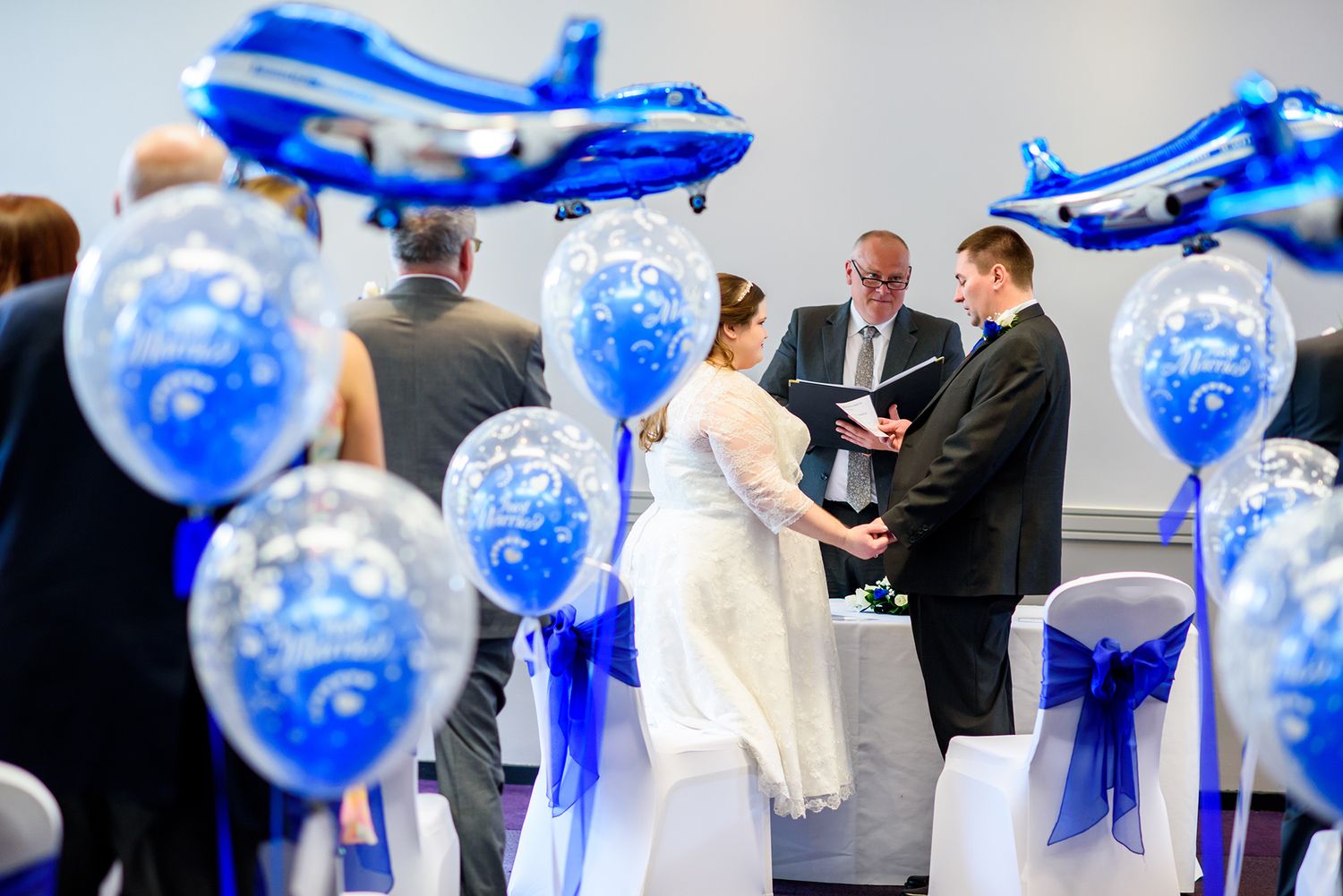 Party venue decorated with elegant blue and white balloon arrangements.