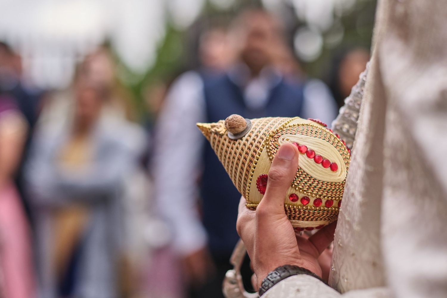 A group of people wearing gold and silver crowns during a celebration event.