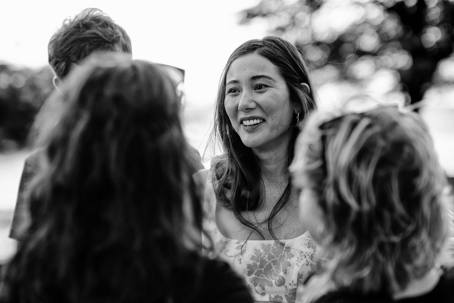 Black and white candid moments captured during an outdoor celebration.