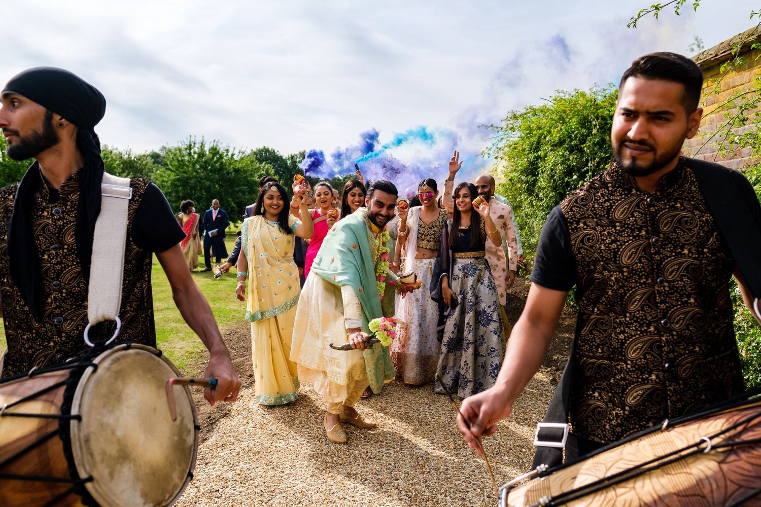 Guests gather outdoors for a cultural celebration with traditional music and entertainment.