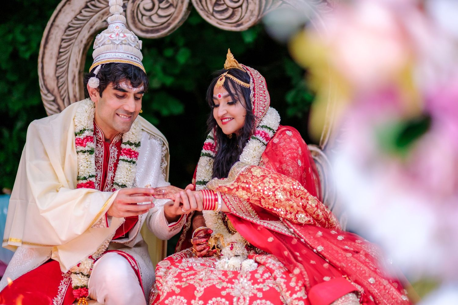 Traditional Indian wedding rituals being performed in an outdoor garden ceremony.