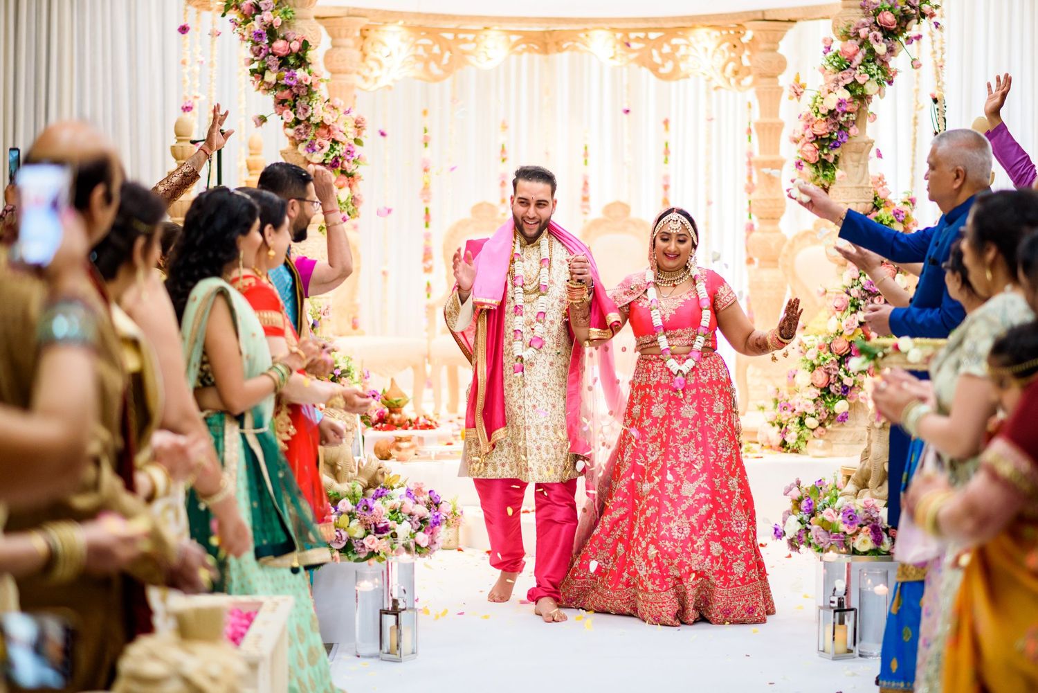 Elegant wedding venue decorated with floral arrangements and soft lighting for an Indian celebration.