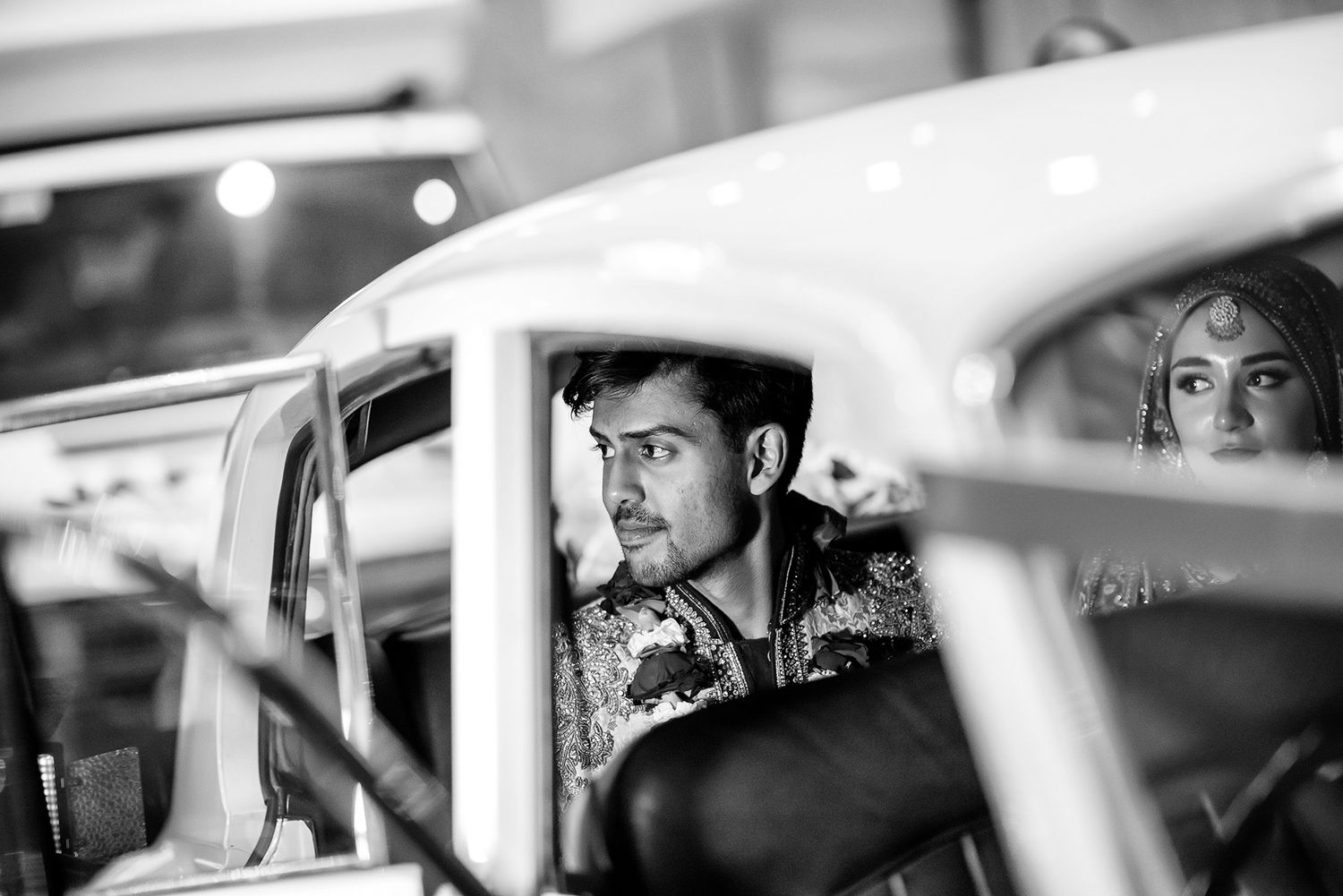 Black and white candid shots through car windows during a wedding.