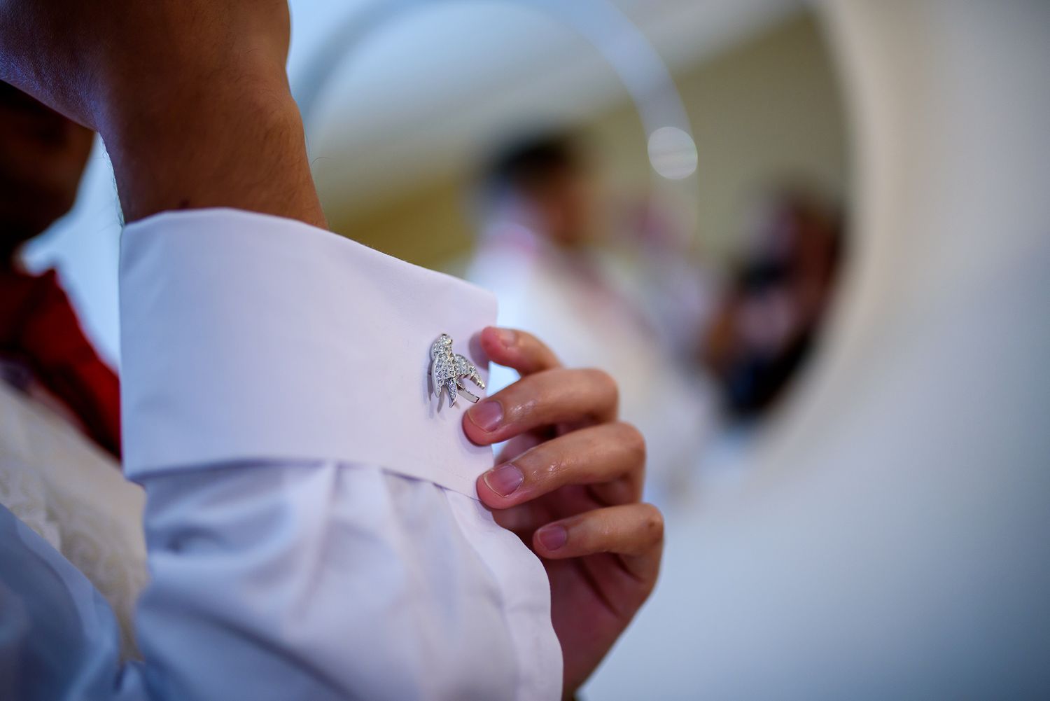 Wedding preparation details showing white dress shirt and formal attire closeups.