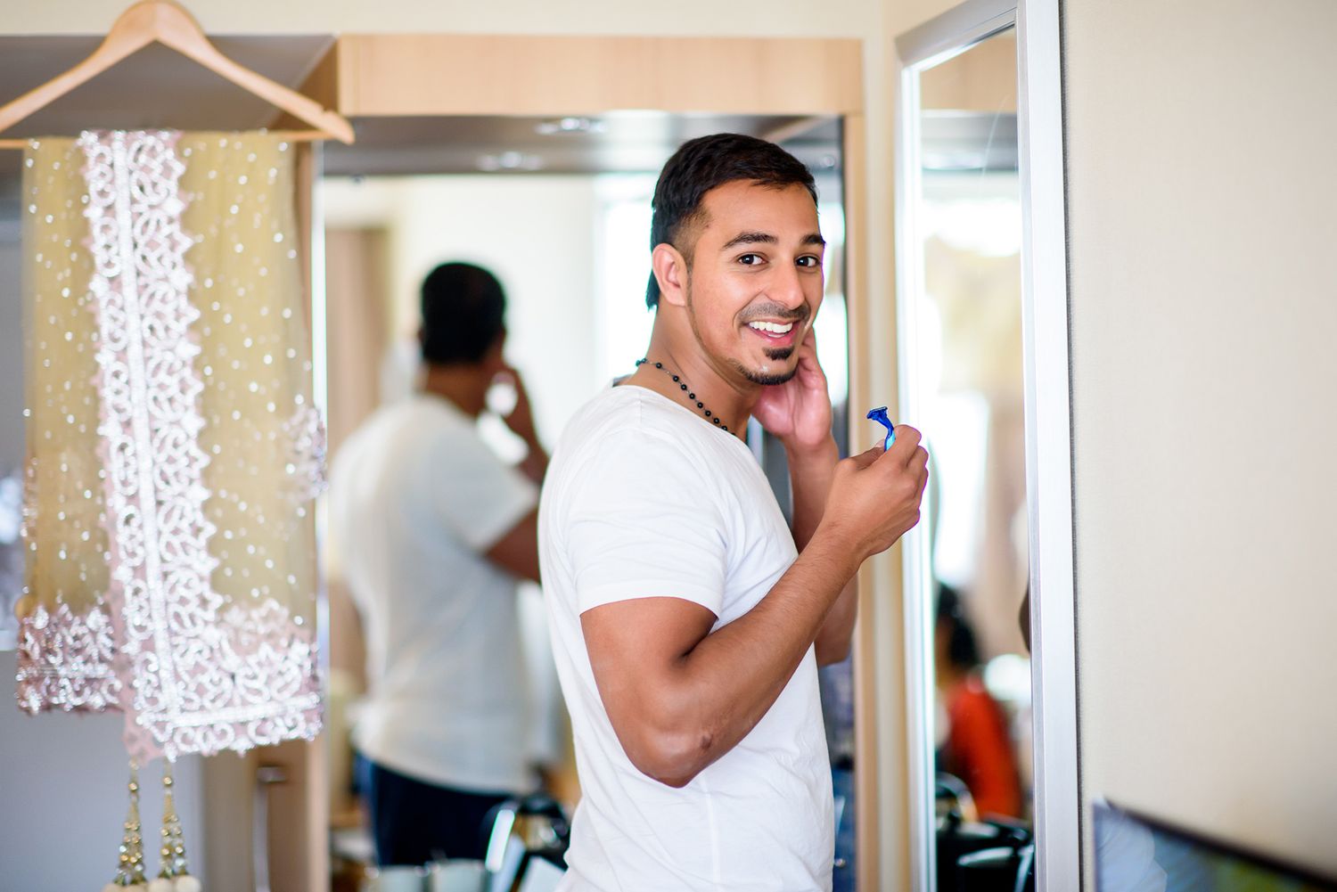 Black and white collage of someone getting ready in a white dress shirt near a decorative lace curtain.