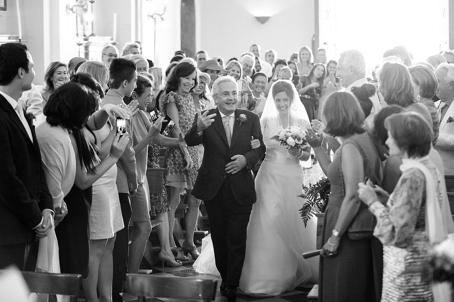 Large group of wedding guests gathered in a church sanctuary.