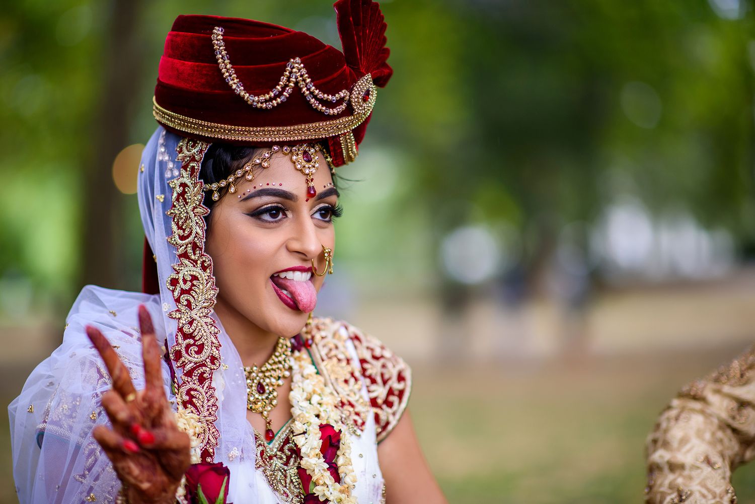 Close-up shot of traditional Indian bridal jewelry and makeup details.