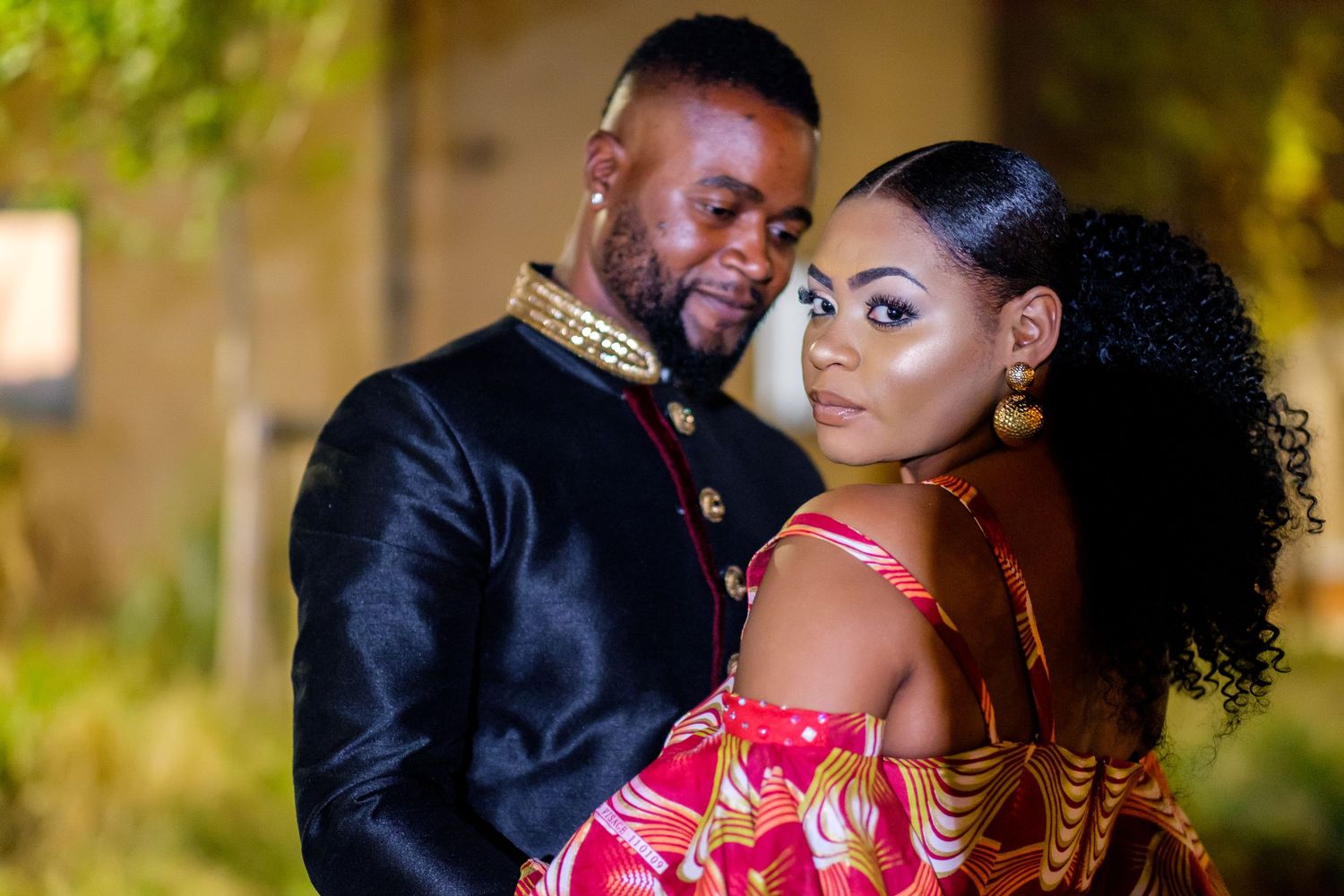 Couple sharing romantic moments during their outdoor wedding photoshoot.