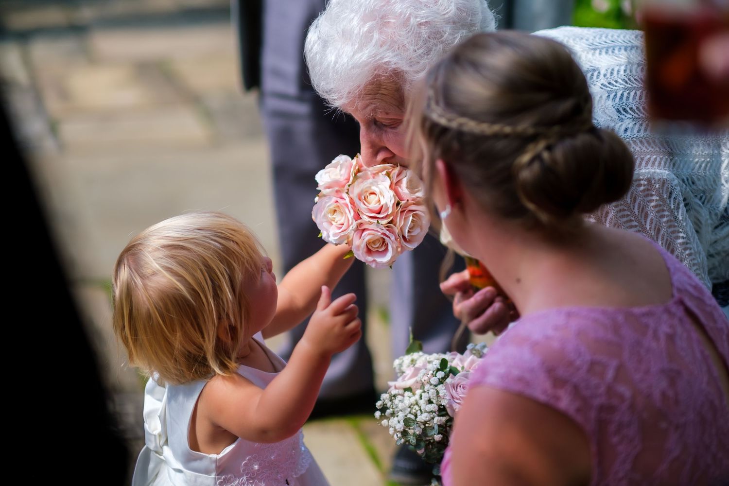 Wedding guests celebrate during an emotional outdoor ceremony moment.