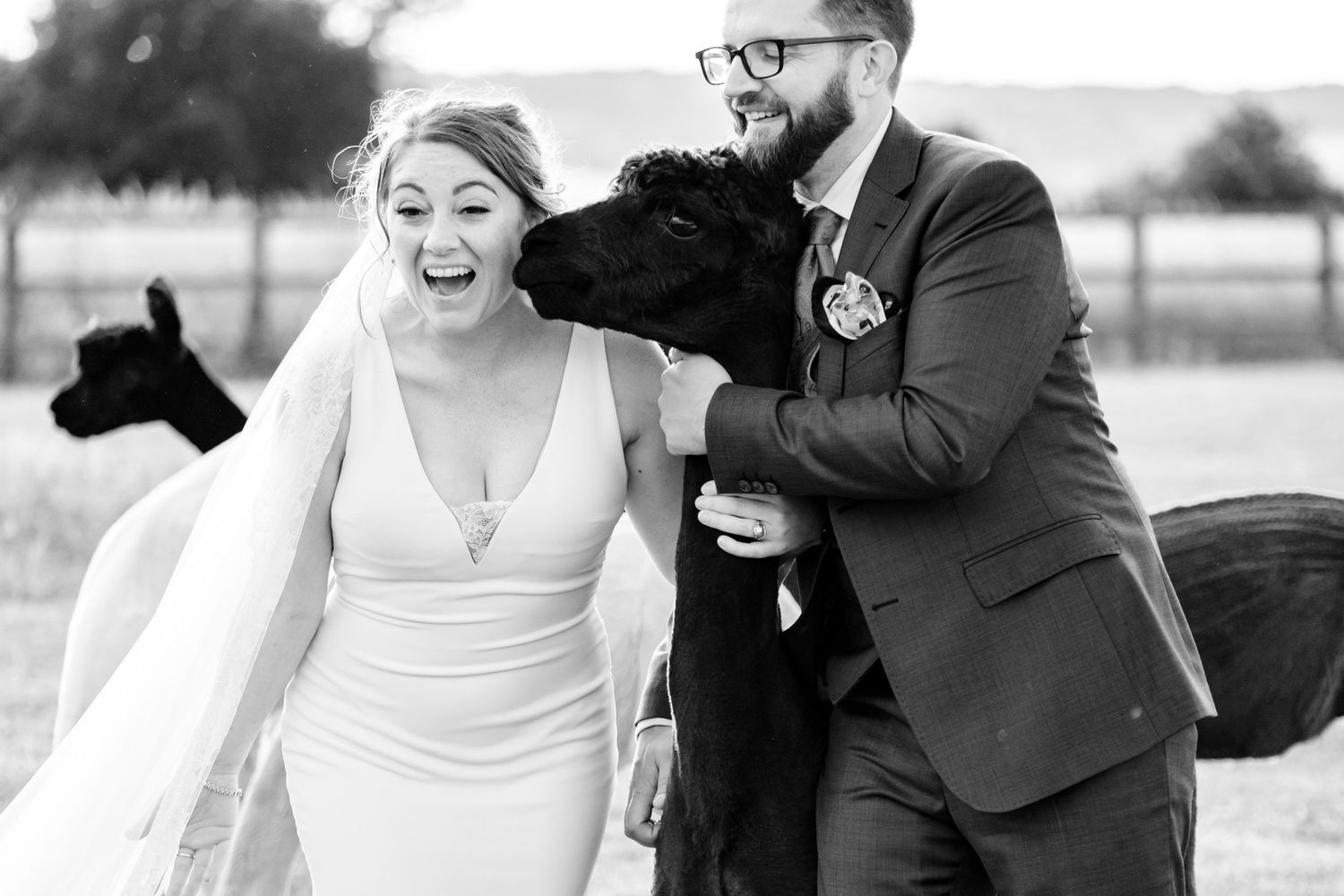 Joyful wedding couple laughing and dancing together in black and white photography.