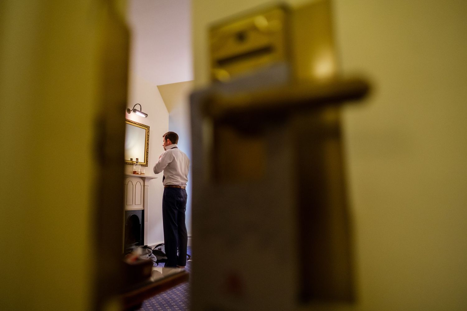 Dimly lit hallway with stone walls and vintage architectural details creates a moody atmosphere.