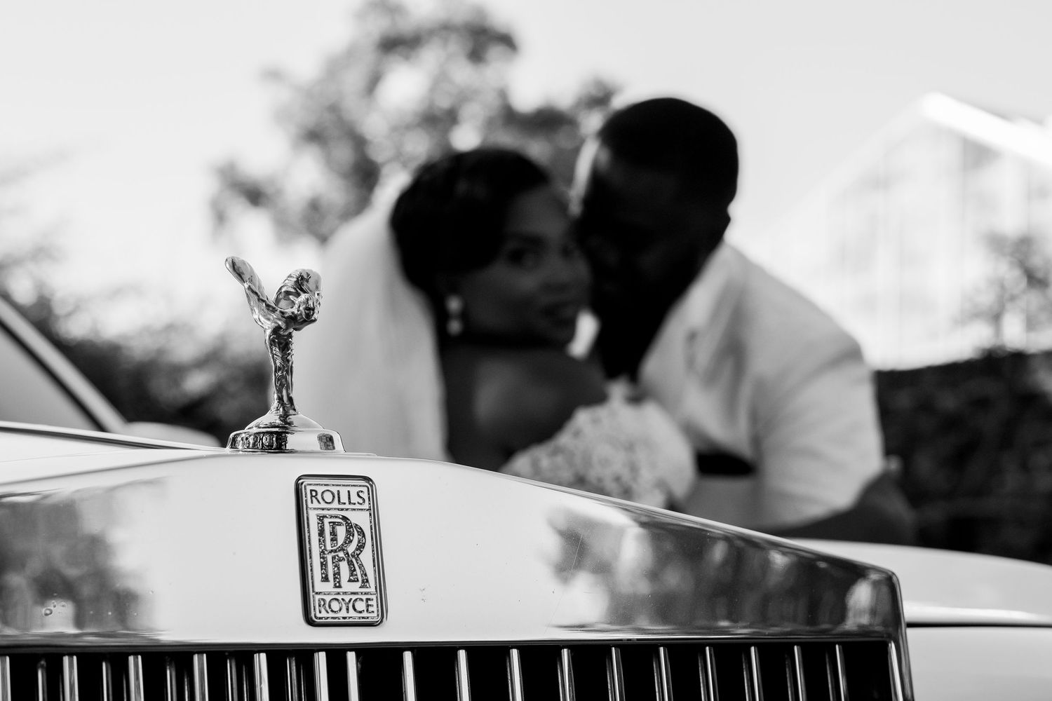Black and white detail shots of luxury car and wedding moments.