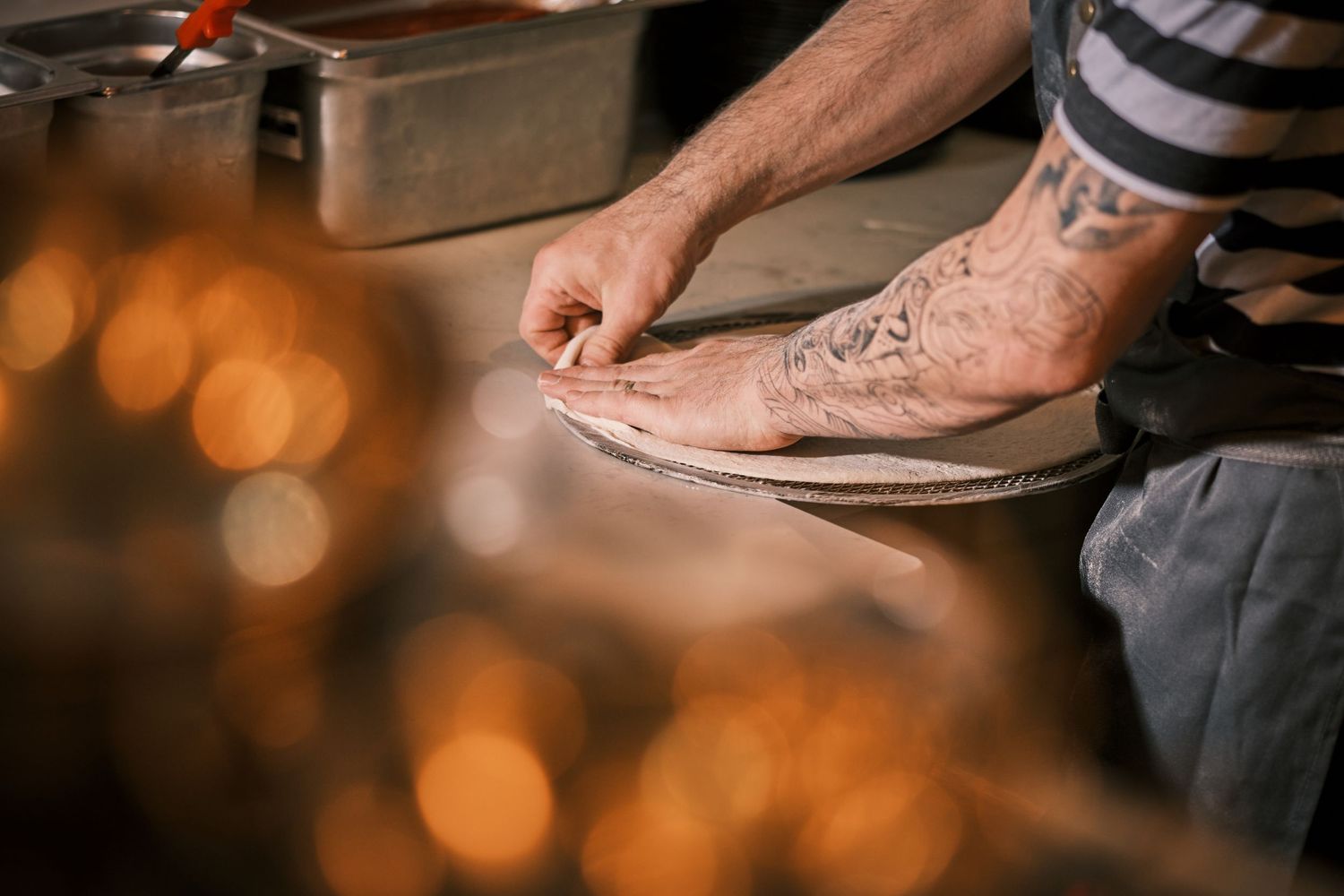 Close-up of hands preparing food ingredients on a wooden cutting board.