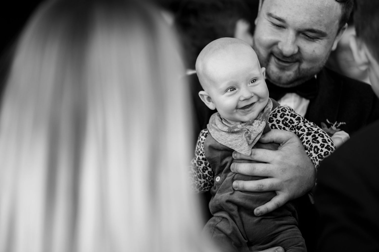 Black and white candid moments showing tender family interactions.