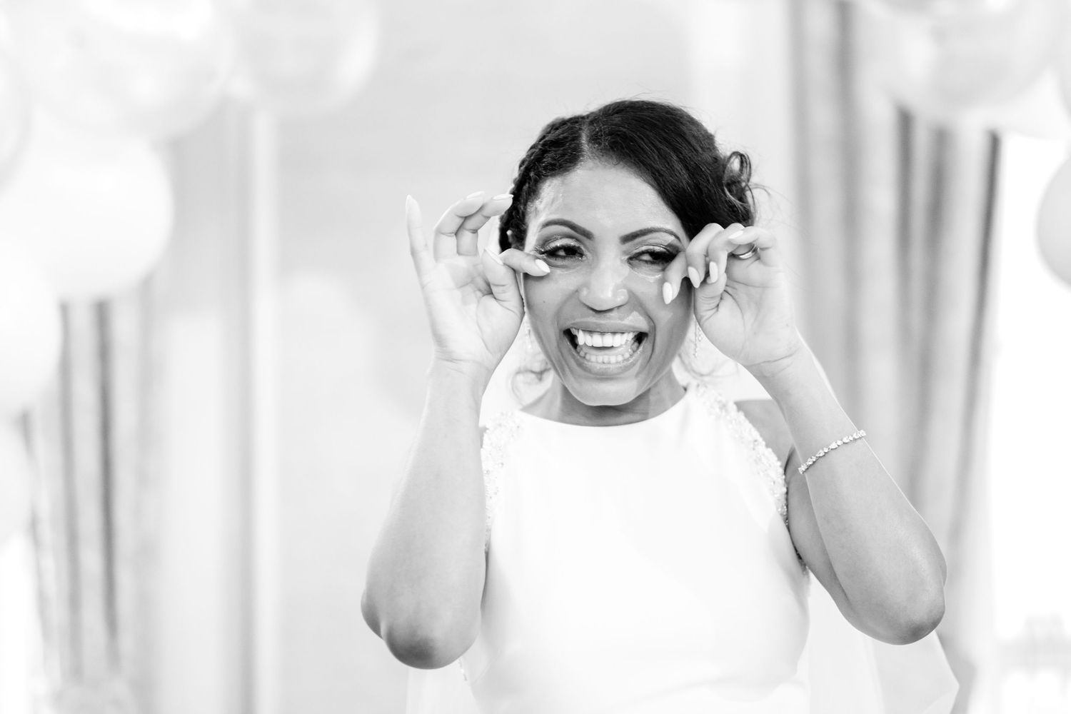 Black and white portrait of joyful wedding guests sharing emotional moments.