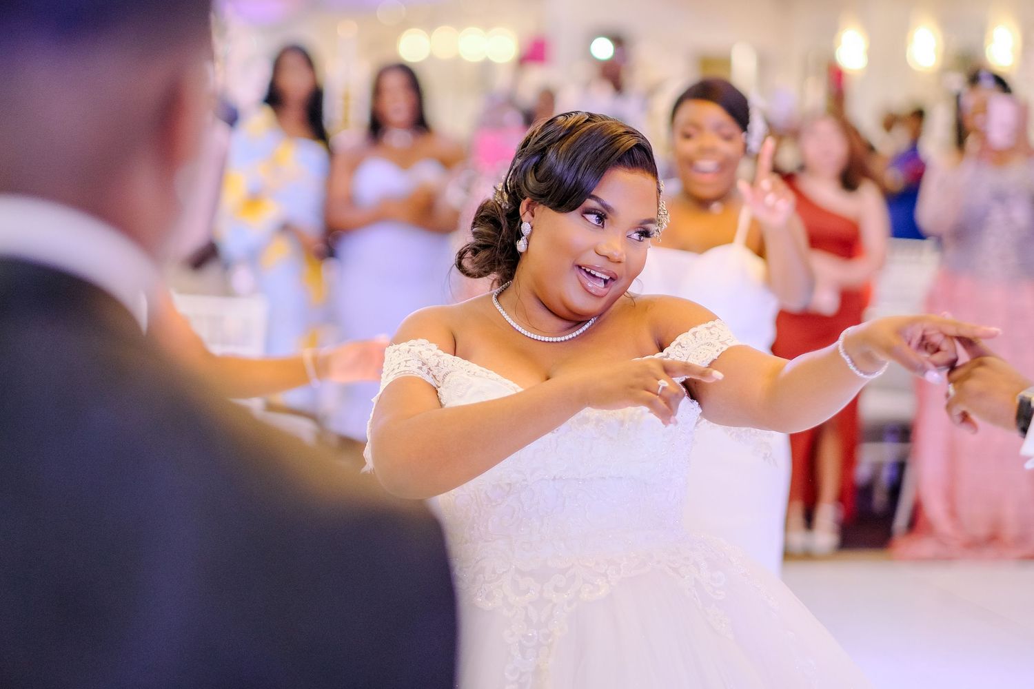 Wedding reception dance floor moments with soft lighting and festive atmosphere.