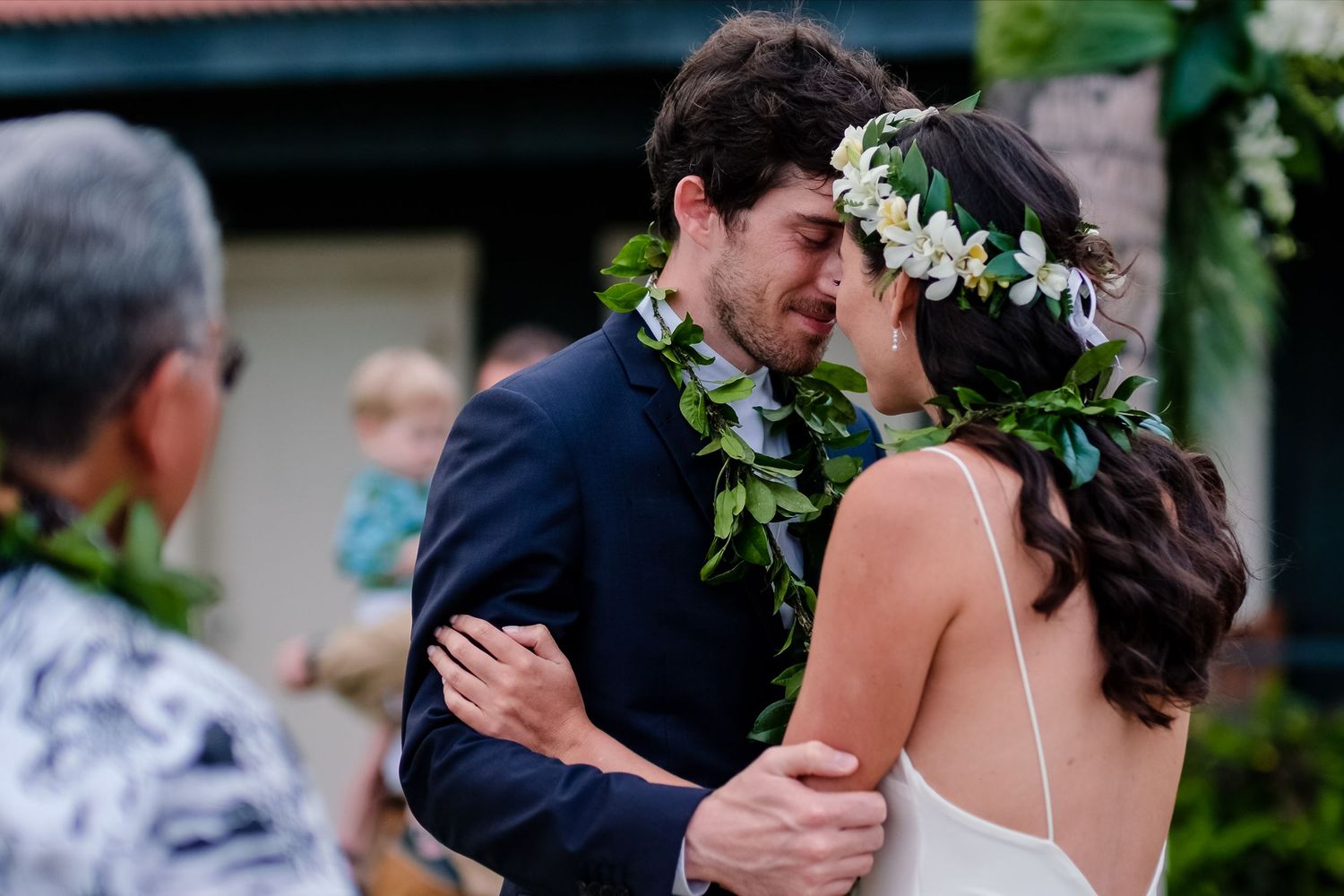 Joyful wedding ceremony moment captured outdoors with floral decorations.