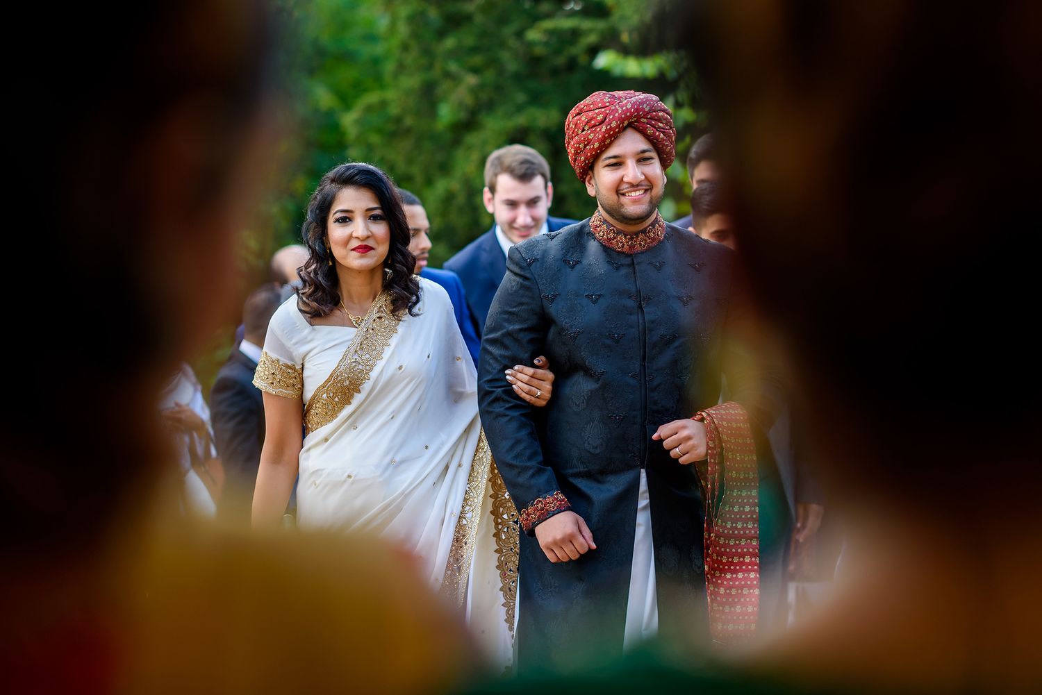 Wedding guests enjoying an outdoor celebration with traditional attire and decorations.