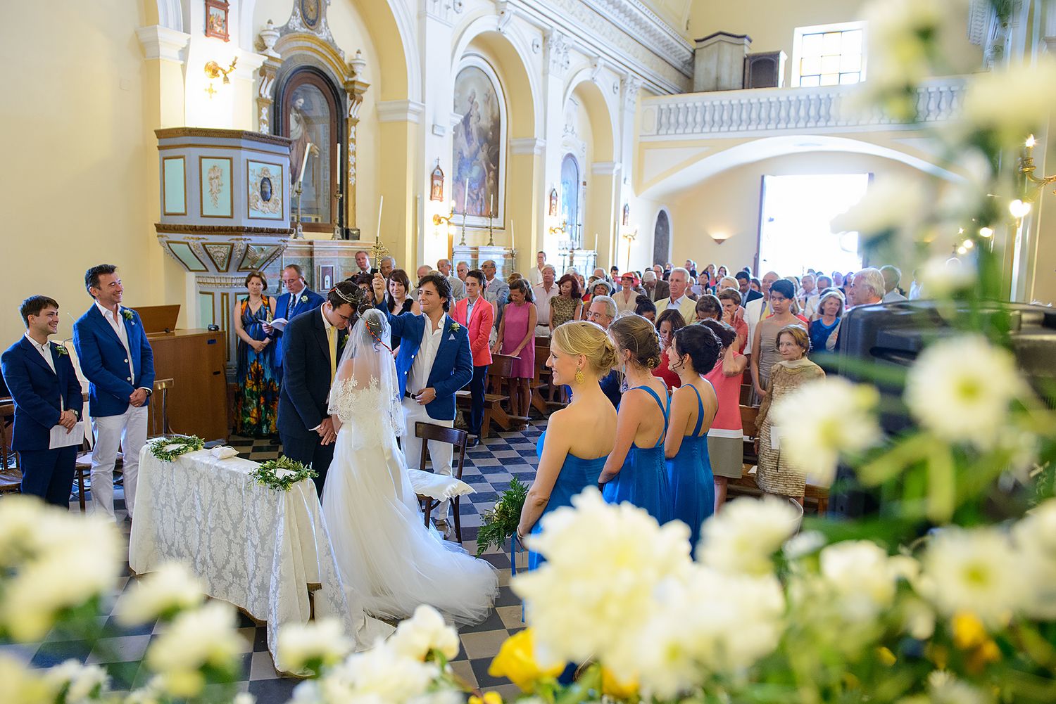 Interior of a beautiful church with yellow flowers and architectural arches.