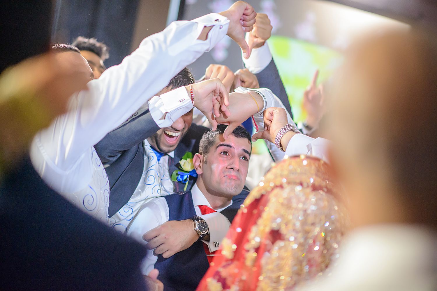 Guests dancing and celebrating at a lively wedding reception.