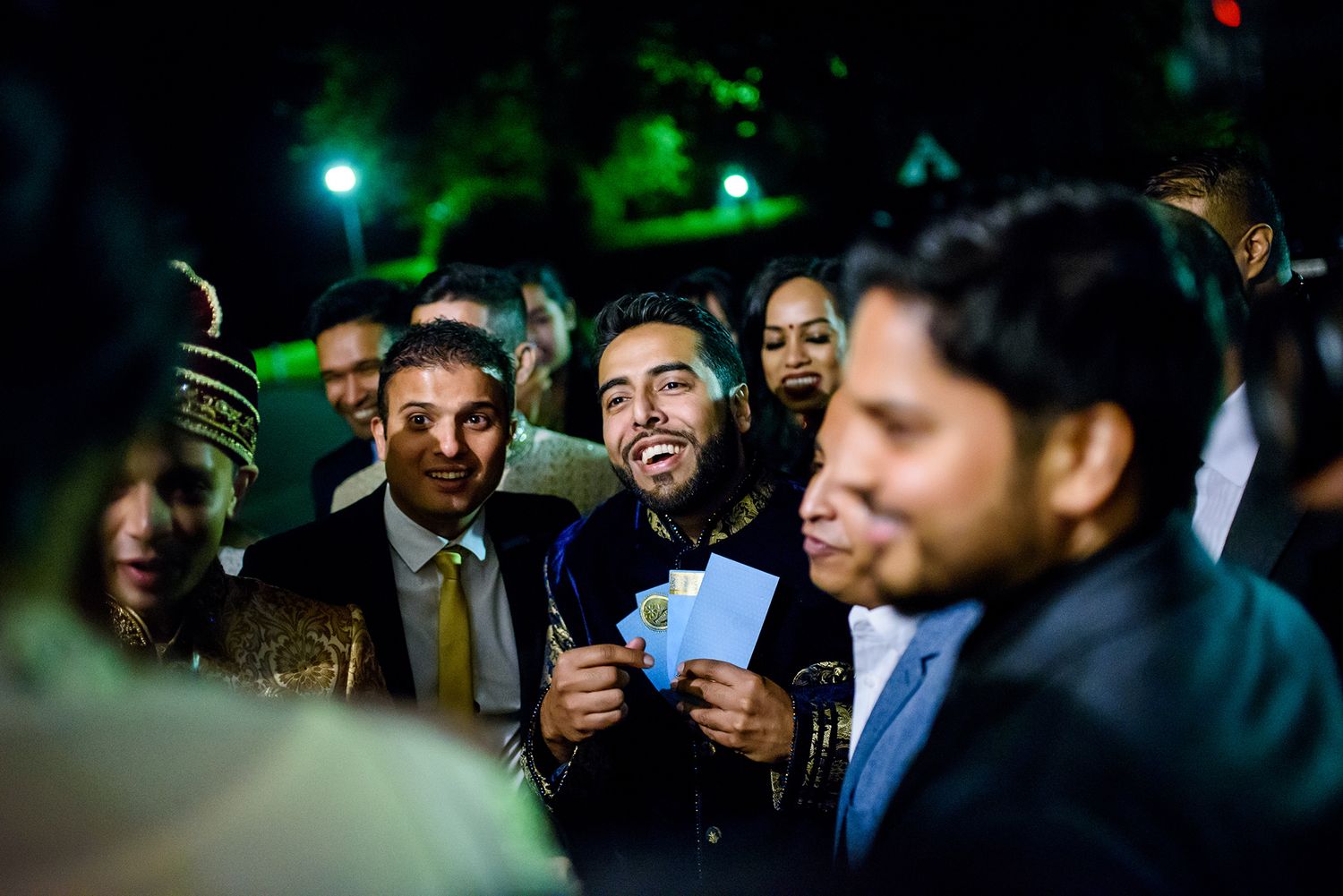 Joyful celebration at an evening wedding reception with formal attire.