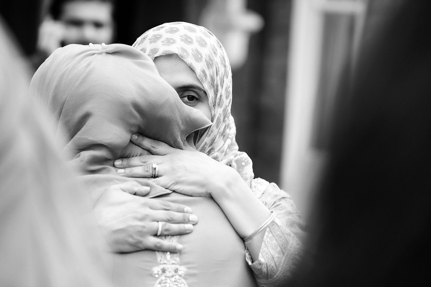 Black and white romantic engagement photo showing a couple laughing together.