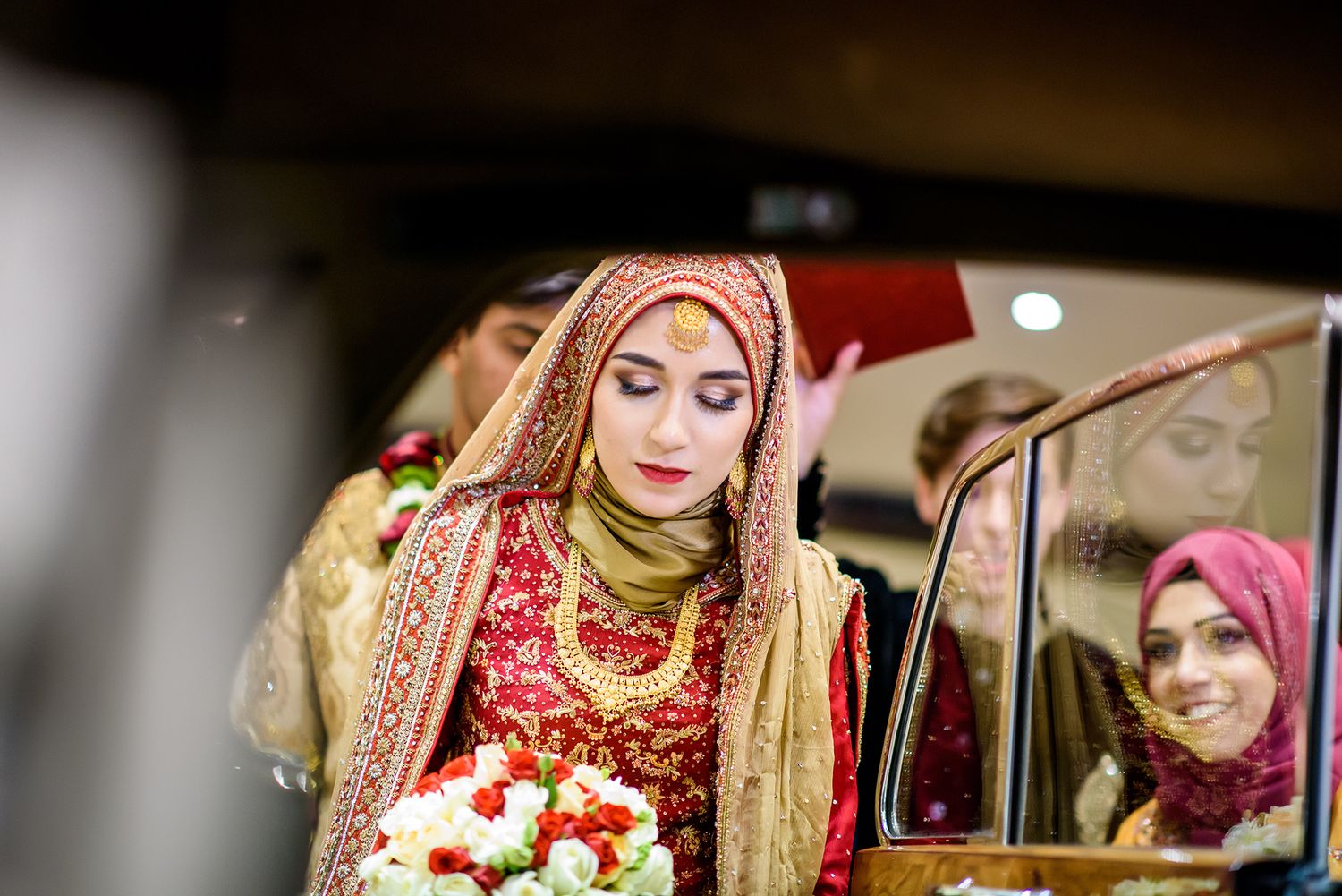Wedding guests and celebrations viewed through car window frames.