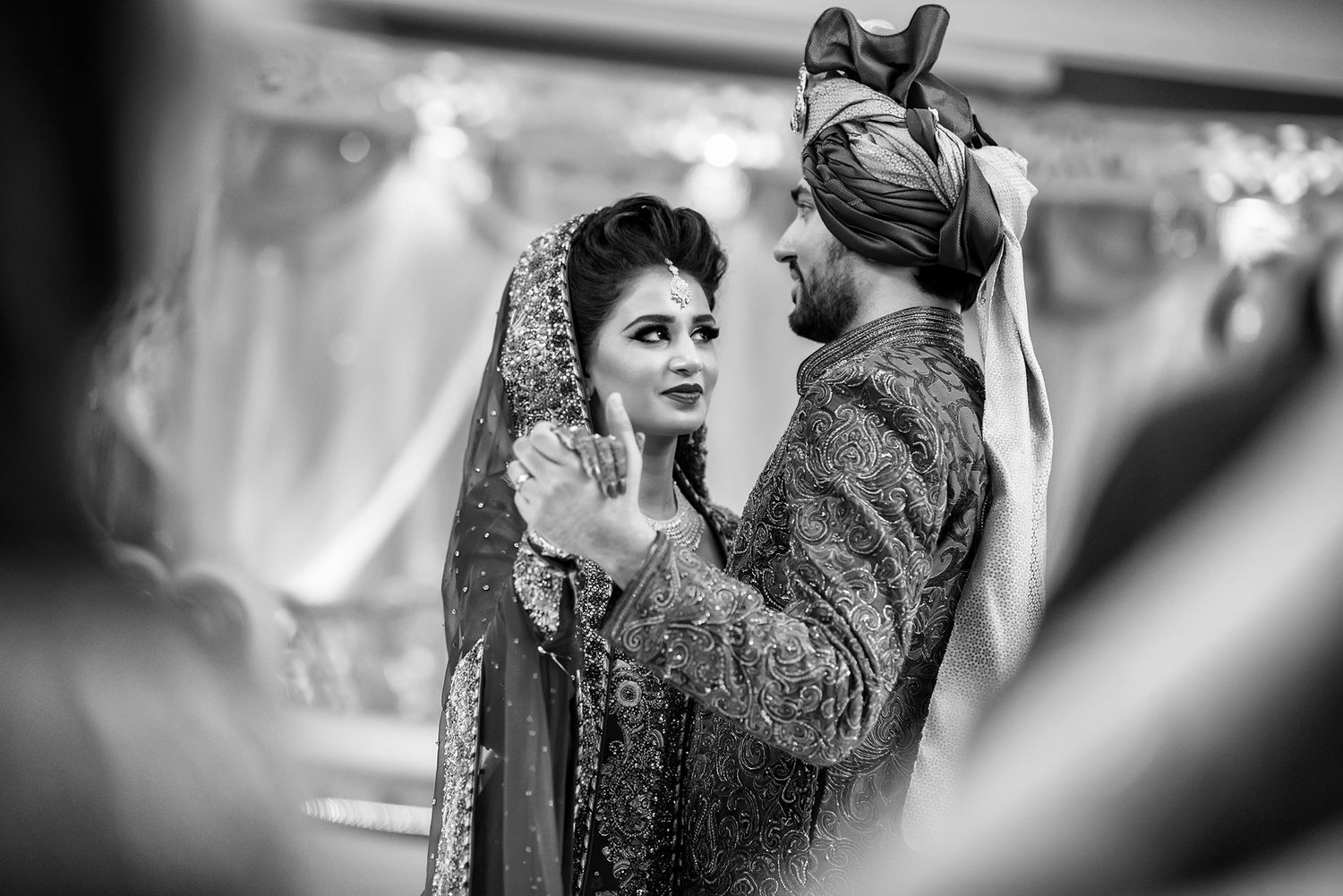 Black and white shots of wedding celebrations with guests in formal attire.
