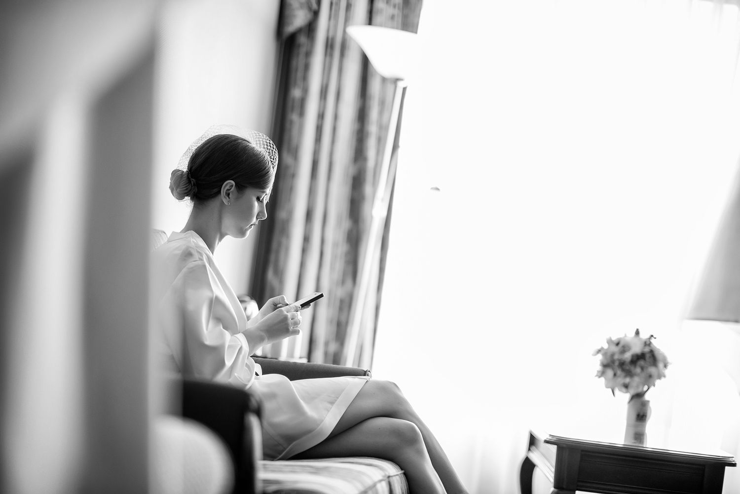 Artistic wedding day preparation moments captured in natural window light.