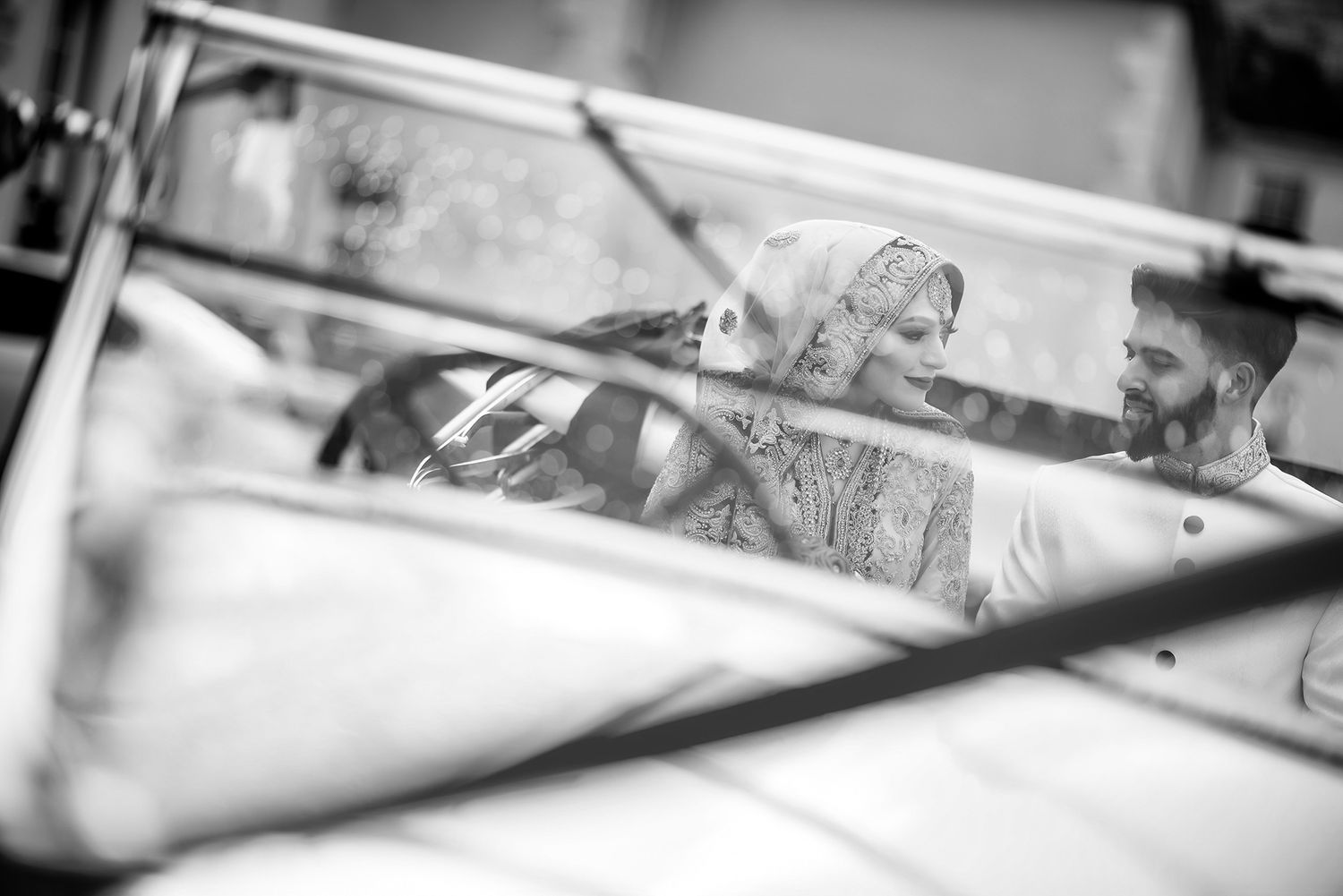 A black and white reflection captured through a car window.