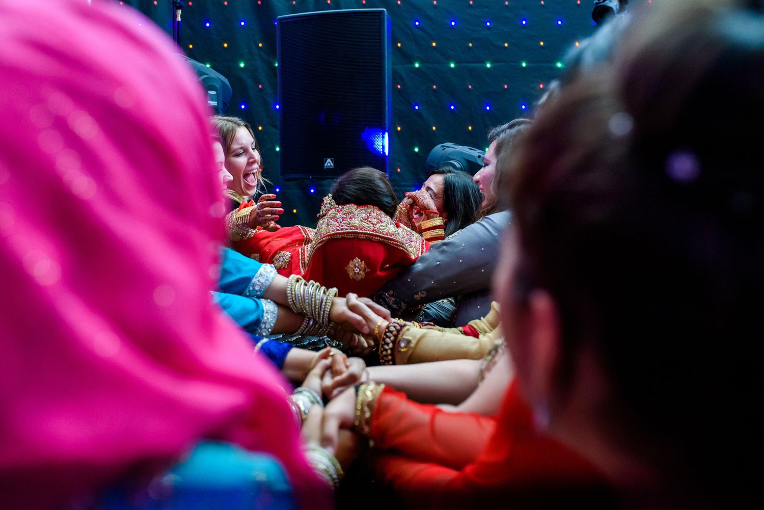 Close-up of hands decorated with henna during traditional wedding rituals.