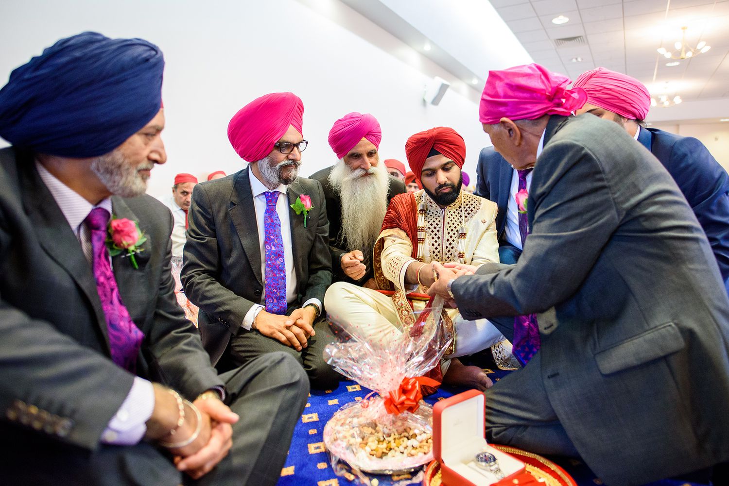 Traditional Sikh wedding ceremony with guests in formal attire.
