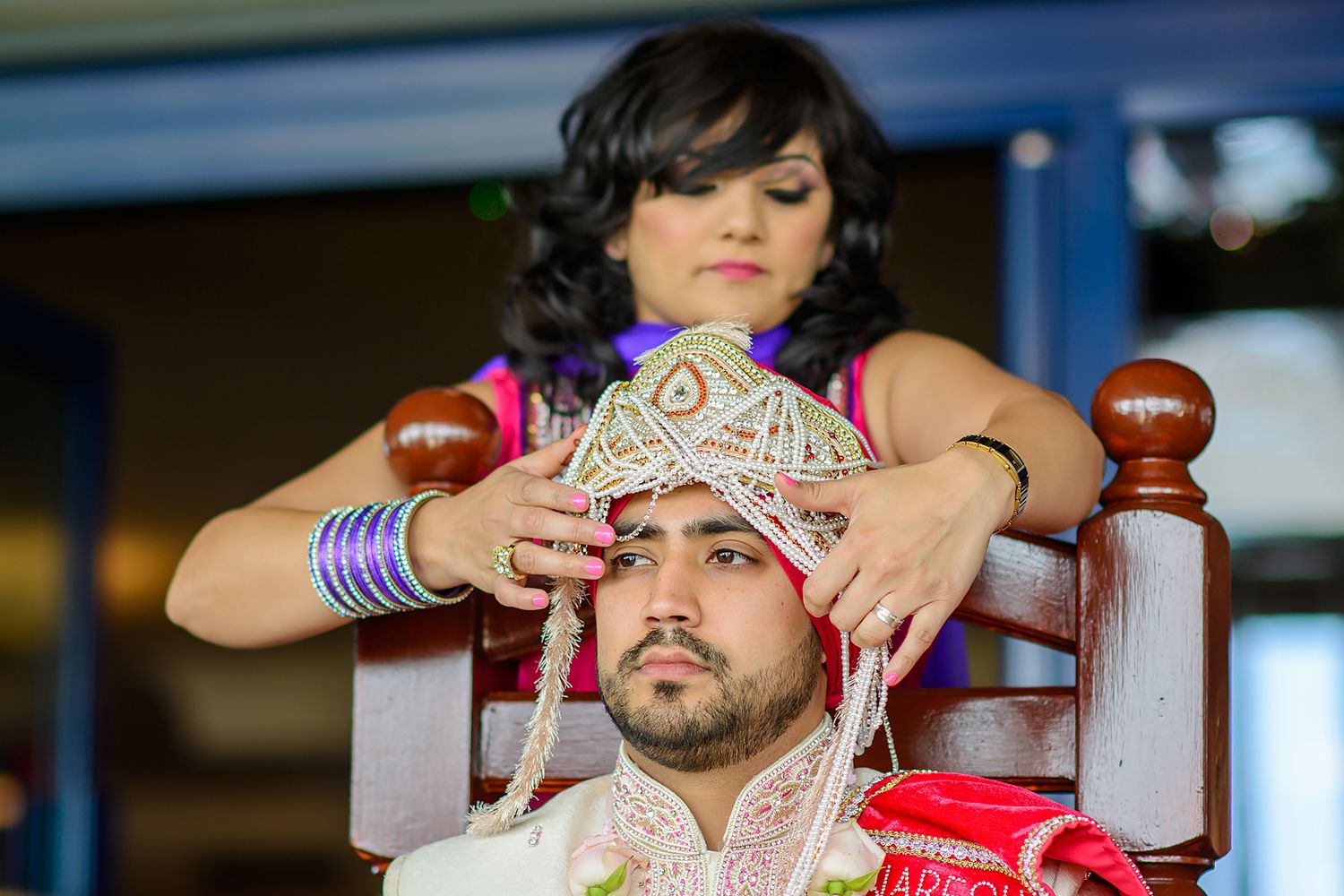 Wedding ritual being performed with traditional red ceremonial items.